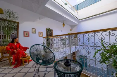 a woman sitting in a chair in a room at Riad Zellige in Marrakech