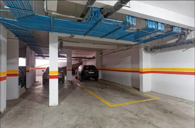 a parking garage with two cars parked in it at Appartement Marrakech 2 Chambres De Luxe Orange in Marrakech