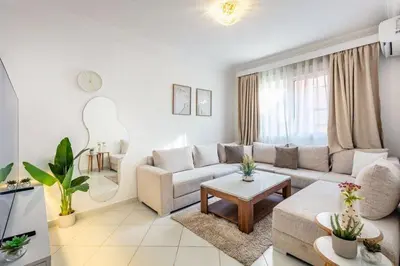 a living room with a couch and a table at Luxueux appartement in Marrakech