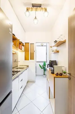 a kitchen with white cabinets and a window at Luxueux appartement in Marrakech