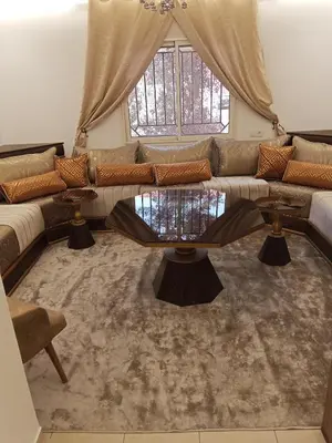 a living room with a couch and a table at Appartement Marrakech in Marrakech