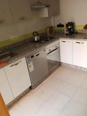 a kitchen with white appliances and a counter top at Appartement Marrakech in Marrakech