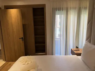 a bedroom with a large white bed and a window at New apartment in Jnane El Guéliz in Marrakech