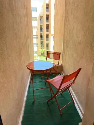 a table and chairs in a room with a window at New apartment in Jnane El Guéliz in Marrakech