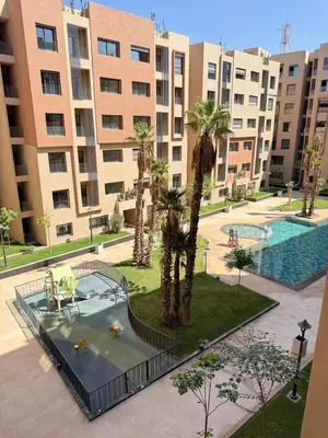 an apartment complex with a swimming pool and palm trees at New apartment in Jnane El Guéliz in Marrakech