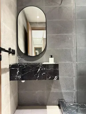 a bathroom with a mirror and a sink at New apartment in Jnane El Guéliz in Marrakech