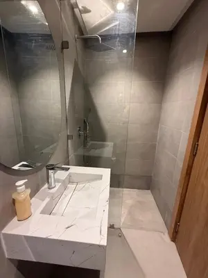 a bathroom with a white sink and a mirror at T3 élégant 2ch piscine chauffée & fitness in Marrakech