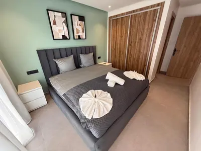a bedroom with a bed with two towels on it at T3 élégant 2ch piscine chauffée & fitness in Marrakech