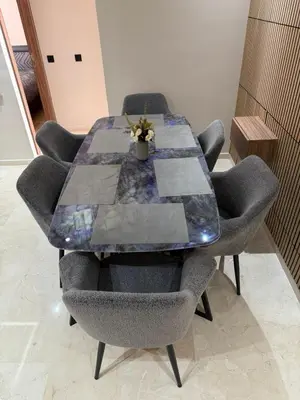 a dining room table with chairs and a blue marble top at Appartement centre ville Marrakech avec Piscine in Marrakech