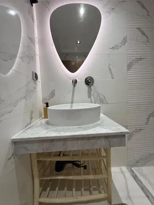 a bathroom with a sink and a mirror at Appartement centre ville Marrakech avec Piscine in Marrakech