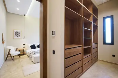 a room with a closet and a bedroom with a bed at Villa Marrakech in Marrakech