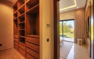 a walk in closet in a house with wooden cabinets at Villa Marrakech in Marrakech