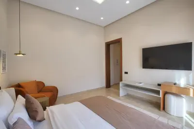 a bedroom with a bed and a television on the wall at Villa Marrakech in Marrakech