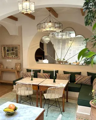 a dining room with a table and chairs at Riad El Badun in Marrakech