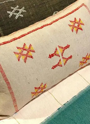 a close up of a pillow with embroidery on it at Riad El Badun in Marrakech