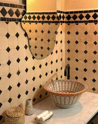 a bathroom with a sink and a mirror at Riad El Badun in Marrakech
