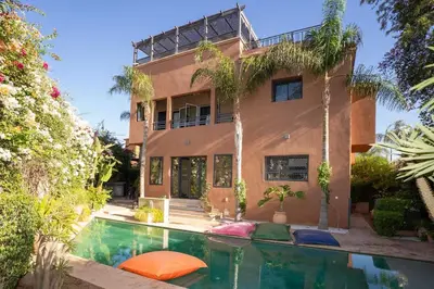 a house with a swimming pool in front of it at Villa luxueuse pour un séjour inoubliable in Marrakech