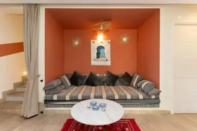 a living room with a couch and a table at Villa luxueuse pour un séjour inoubliable in Marrakech