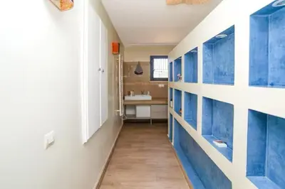 a hallway with blue cabinets and a sink in a bathroom at Villa luxueuse pour un séjour inoubliable in Marrakech