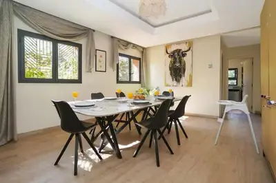 a dining room with a table and chairs at Villa luxueuse pour un séjour inoubliable in Marrakech