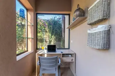 a room with a desk with a laptop and a window at Villa luxueuse pour un séjour inoubliable in Marrakech