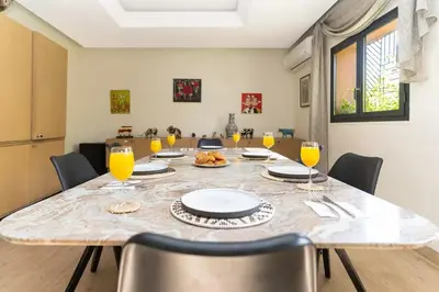 a dining room with a table with glasses of orange juice at Villa luxueuse pour un séjour inoubliable in Marrakech