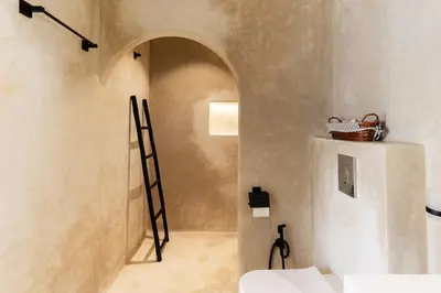 a bathroom with a ladder in the corner of a room at Architect's studio in the city center! in Marrakech