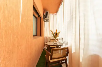 a small table and chairs in a room with a window at Architect's studio in the city center! in Marrakech