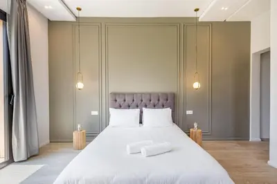 a bedroom with a large bed with two white pillows at Villa Amelkis avec Piscine - 4 suites de luxe à Marrakech in Marrakech