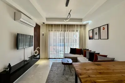 a living room with a couch and a table at Cosy Apartment with Balcony and Pool in Noria Golf in Marrakech