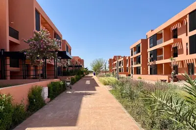 a walkway between two apartment buildings at Cosy Apartment with Balcony and Pool in Noria Golf in Marrakech