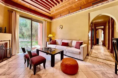 a living room with a couch and a table at Two Bedroom Garden Apartment in Palmeraie 2 in Marrakech