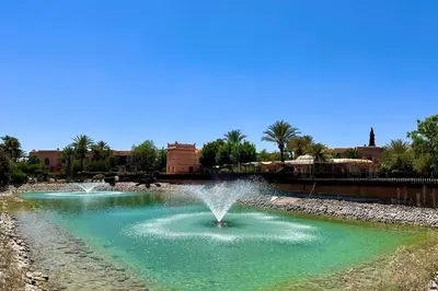 a fountain in the middle of a pond at Two Bedroom Garden Apartment in Palmeraie 2 in Marrakech