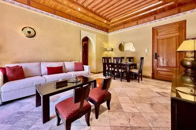 a living room with a couch and a table at Two Bedroom Garden Apartment in Palmeraie 2 in Marrakech