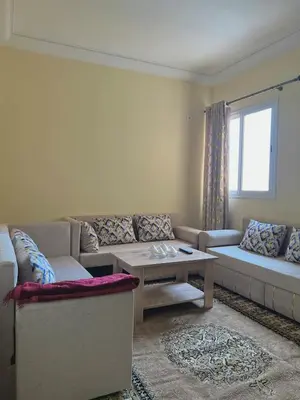 a living room with a couch and a coffee table at Apartment 5 minutes from the airport in Marrakech
