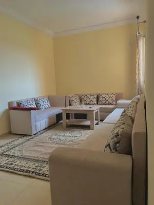 a living room with two couches and a table at Apartment 5 minutes from the airport in Marrakech