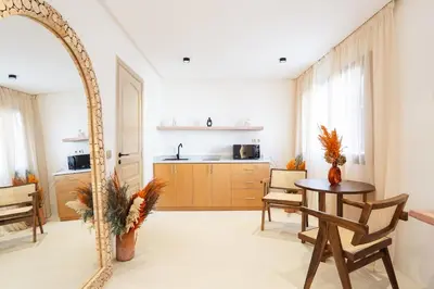 a living room with a table and a mirror at Refined studio in the city center! in Marrakech
