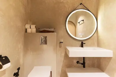 a bathroom with a sink and a mirror at Refined studio in the city center! in Marrakech
