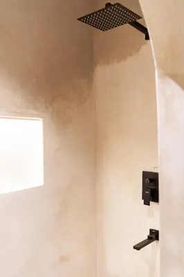 a bathroom with a window and a light fixture on the wall at Refined studio in the city center! in Marrakech