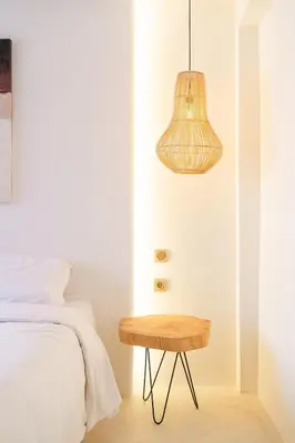 a bedroom with a bed and a wooden table at Refined studio in the city center! in Marrakech