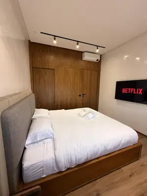 a bed in a room with a sign on the wall at Villa Aliya in Marrakech
