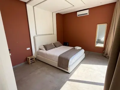 a bedroom with a bed and a large window at Ayline house in Marrakech