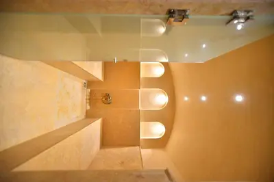 a bathroom with a shower with a glass wall at Luxury villa with heated pool and Hamam in Marrakech