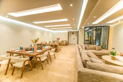 a living room with a couch and a table and chairs at Luxury villa with heated pool and Hamam in Marrakech
