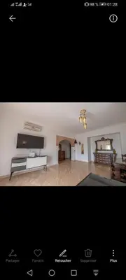 a living room with a couch and a tv at pation et jardin in Marrakech