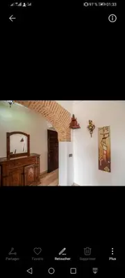 a picture of a living room with a room with a table at pation et jardin in Marrakech