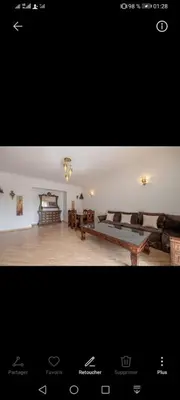 a large living room with a couch and a table at pation et jardin in Marrakech