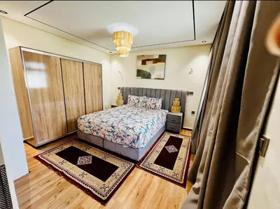 a bedroom with a bed and two rugs at Appartement Jamaa El Fna View in Marrakech