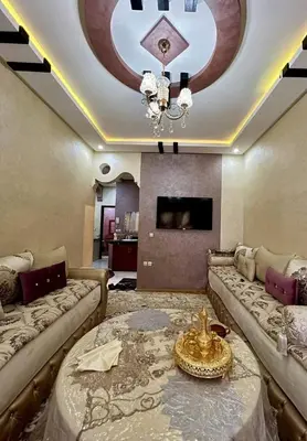 a living room with two couches and a chandelier at Appartement Jamaa El Fna View in Marrakech