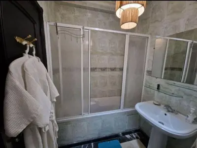 a bathroom with a shower and a sink at Appartement 2 chambres, piscine, vue palmeraie in Marrakech